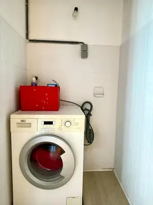 a washing machine with a red box on top of it at 3 min to the Grand-Place 6 min to Manneken Pis & Sleeps 6 in Brussels