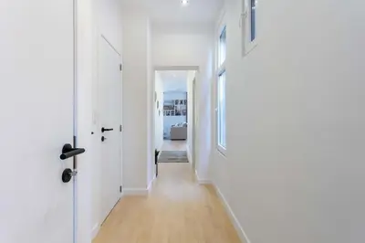 a hallway with two white doors and a hallway with a hallway at Beautiful loft in Antwerp Berchem in Antwerp
