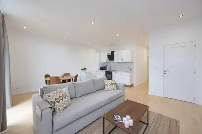 a living room with a couch and a table at Beautiful loft in Antwerp Berchem in Antwerp
