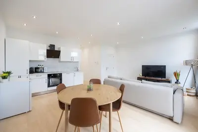 a kitchen and living room with a table and a couch at Beautiful loft in Antwerp Berchem in Antwerp