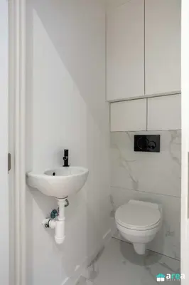 a white bathroom with a sink and a toilet at Beautiful loft in Antwerp Berchem in Antwerp