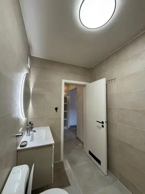 a bathroom with a white sink and a toilet at cozy apartment in Brussels in Brussels