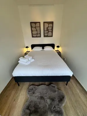 a bedroom with a bed with a stuffed animal on the floor at cozy apartment in Brussels in Brussels