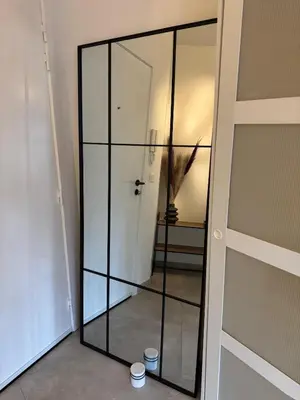 a glass closet with two cups in a room at cozy apartment in Brussels in Brussels