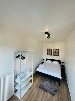 a bedroom with a bed and a book shelf at cozy apartment in Brussels in Brussels