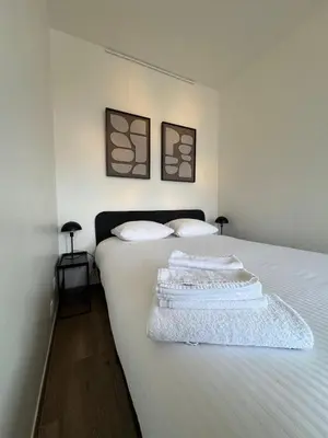 a bedroom with a bed with two towels on it at cozy apartment in Brussels in Brussels