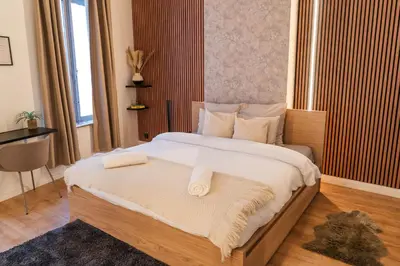 a bedroom with a large bed with towels on it at 5BR Apartment in the Heart of Ghent for Groups in Ghent