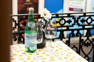 a bottle of wine and two glasses on a table at 5BR Apartment in the Heart of Ghent for Groups in Ghent