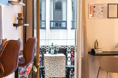 a room with a table and chairs and a window at 5BR Apartment in the Heart of Ghent for Groups in Ghent