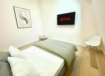 a white room with a bed and a chair at Rooms at Université Libre de Bruxelles in Brussels