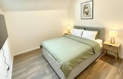 a small bedroom with a bed and two lamps at Rooms at Université Libre de Bruxelles in Brussels