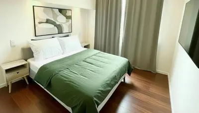 a bedroom with a bed with a green comforter at Rooms at Université Libre de Bruxelles in Brussels
