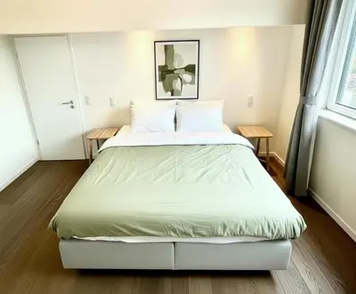 a bedroom with a large bed with white sheets at Rooms at Université Libre de Bruxelles in Brussels