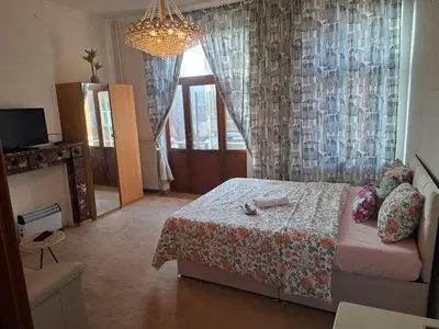 a bedroom with a bed and a chandelier at Chambres dans un Immeuble in Brussels