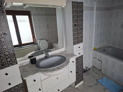 a bathroom with a sink and a tub at Chambres dans un Immeuble in Brussels