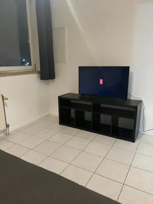 a living room with a tv on a table at Modern 1BR and Sofa Bed Near Airport in Brussels