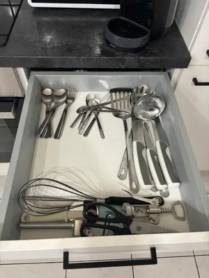 a drawer filled with utensils in a kitchen at Modern 1BR and Sofa Bed Near Airport in Brussels