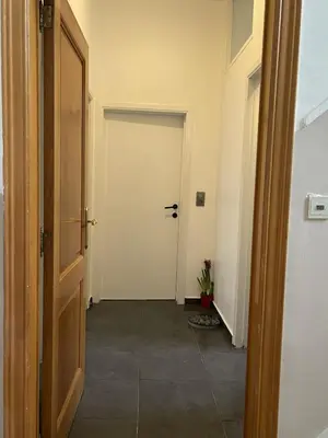 a hallway with a door leading to a room at Beautiful condominium with jacuzzi in Brussels