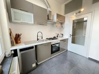 a kitchen with a sink and a stove at Beautiful condominium with jacuzzi in Brussels