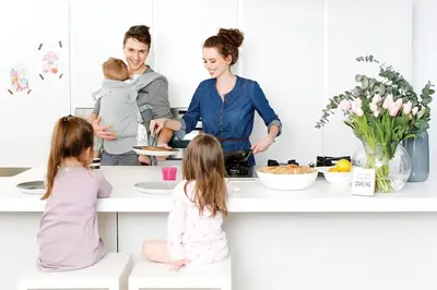 a family in a kitchen with a woman holding a child at Premium Loft in Antwerp Featured on TV in Antwerp