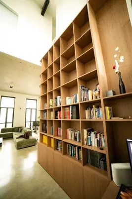 a library with wooden shelves filled with books at Premium Loft in Antwerp Featured on TV in Antwerp