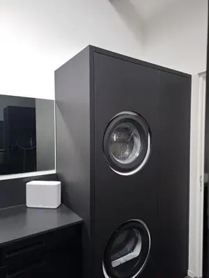 a black cabinet with two washing machines in it at Premium Loft in Antwerp Featured on TV in Antwerp