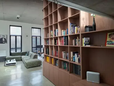 a library with wooden shelves filled with books at Premium Loft in Antwerp Featured on TV in Antwerp