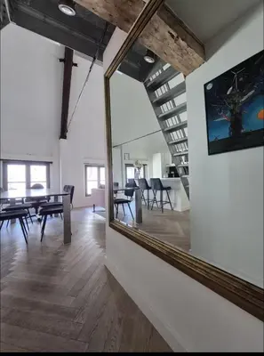 a mirror in a room with a table and chairs at Chique loft uitzicht kathedraal Antwerpen in Antwerp