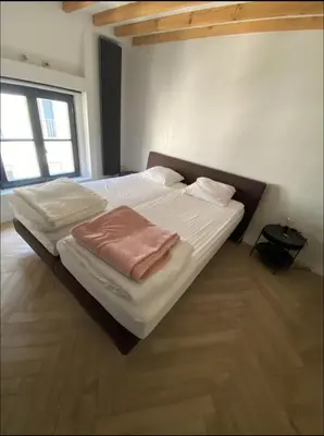 a bedroom with a large bed with white sheets at Chique loft uitzicht kathedraal Antwerpen in Antwerp