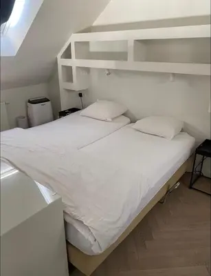 a white bed in a room with a bunk at Chique loft uitzicht kathedraal Antwerpen in Antwerp