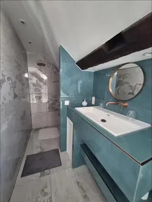 a blue bathroom with a sink and a mirror at Chique loft uitzicht kathedraal Antwerpen in Antwerp