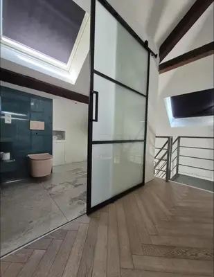 an open glass door in a room with a toilet at Chique loft uitzicht kathedraal Antwerpen in Antwerp