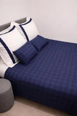 a blue and white bed with two pillows on it at Studio confortable situé à Woluwe Saint Lambert in Brussels
