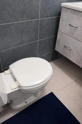 a bathroom with a white toilet and a sink at Studio confortable situé à Woluwe Saint Lambert in Brussels