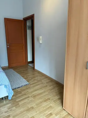 an empty room with a mirror and a door at Chambres et appartement dans un immeuble in Brussels