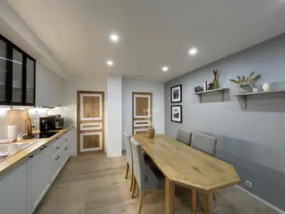 a kitchen and dining room with a wooden table at Rooms Brussels Airport- 'The Good Place' in Zaventem