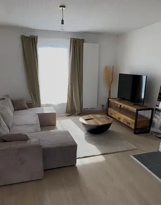 a living room with a couch and a flat screen tv at Antwerp West Side, Fireplace in Zwijndrecht