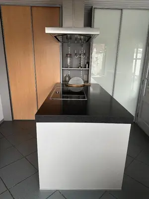 a kitchen with a black and white counter top at Antwerp West Side, Fireplace in Zwijndrecht