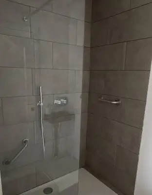 a bathroom with a shower with a glass door at Antwerp West Side, Fireplace in Zwijndrecht