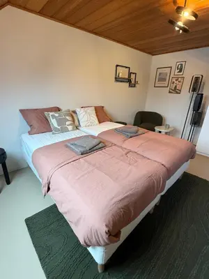 a bedroom with two beds in a room at Vakantiewoning - Camping Groenpark in Berlare