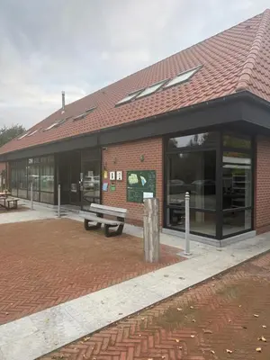 a brick building with a bench in front of it at Vakantiewoning - Camping Groenpark in Berlare