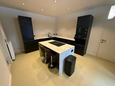 a kitchen with a island in the middle of a room at Vakantiewoning - Camping Groenpark in Berlare