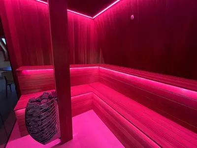 a sauna with pink lights in a red room at Vakantiewoning - Camping Groenpark in Berlare