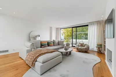 a white living room with a couch and a tv at Ultra-luxe penthouse, 3 slpks, toplocatie in Antwerp