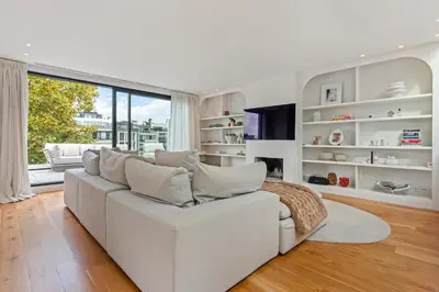 a living room with a white couch and a large window at Ultra-luxe penthouse, 3 slpks, toplocatie in Antwerp