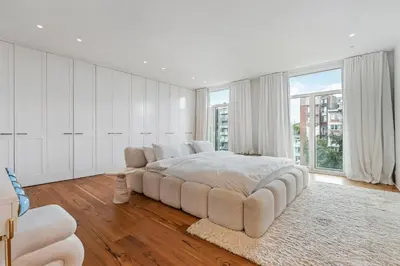 a white bedroom with a large bed and a large window at Ultra-luxe penthouse, 3 slpks, toplocatie in Antwerp