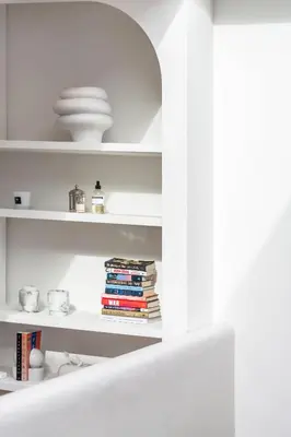 a white shelf with books and plates on it at Ultra-luxe penthouse, 3 slpks, toplocatie in Antwerp