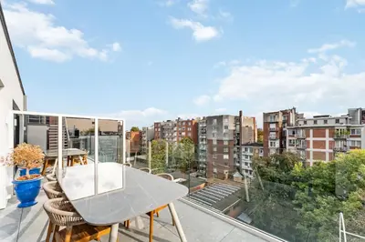 a balcony with a table and chairs and a city at Ultra-luxe penthouse, 3 slpks, toplocatie in Antwerp