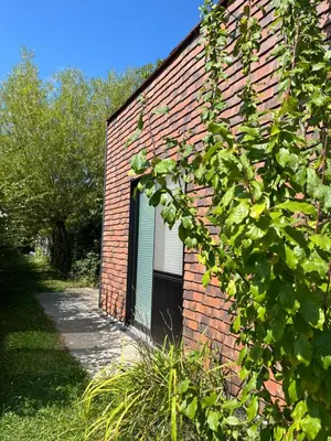 a brick building with a window on the side of it at Bellefleur Cottage in Herent