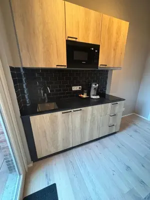 a kitchen with a sink and a microwave at Apartment central Lier in Lier